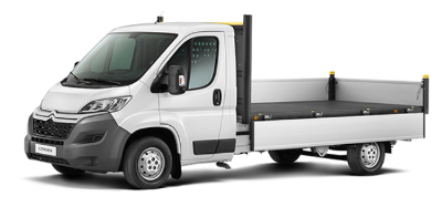 White flatbed truck shown from the side.