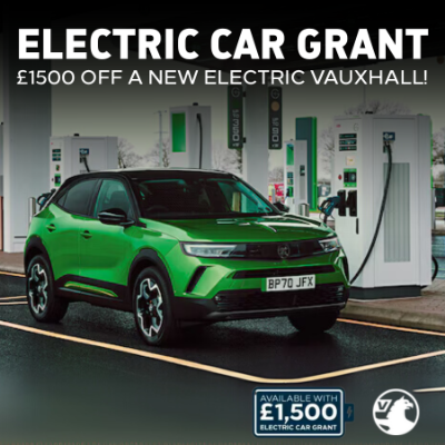 Green Vauxhall electric car at a charging station with grant offer text overlay.