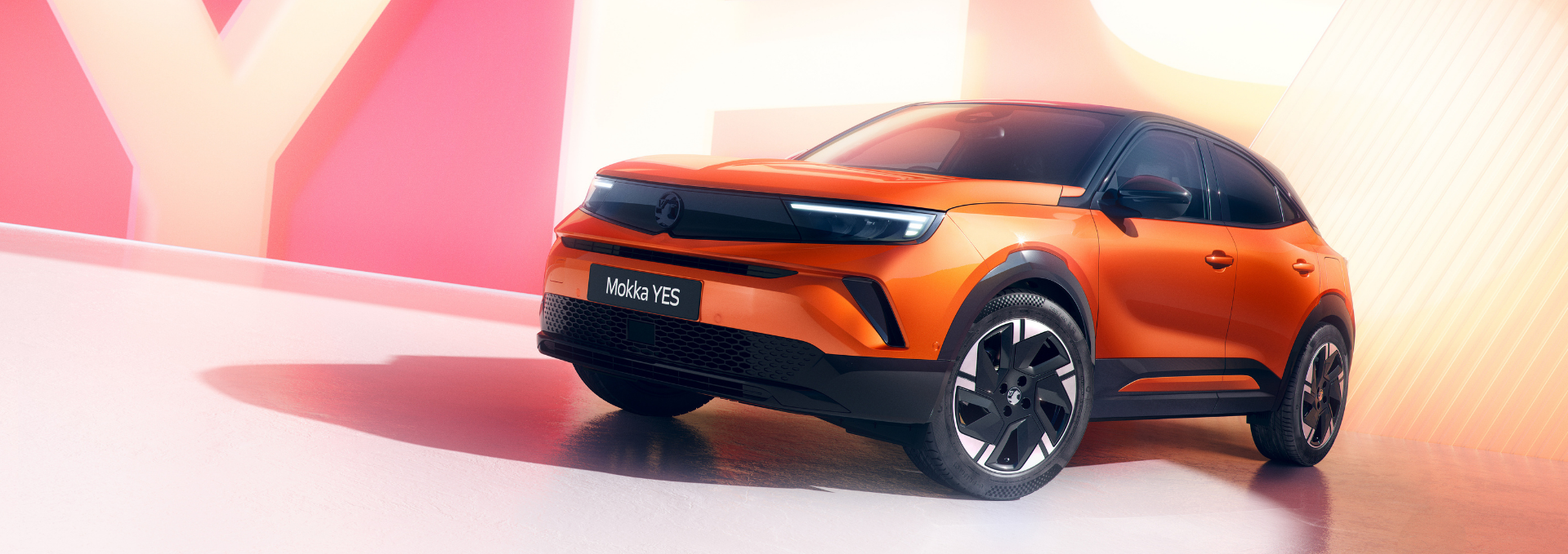 Orange Mokka YES car parked indoors.