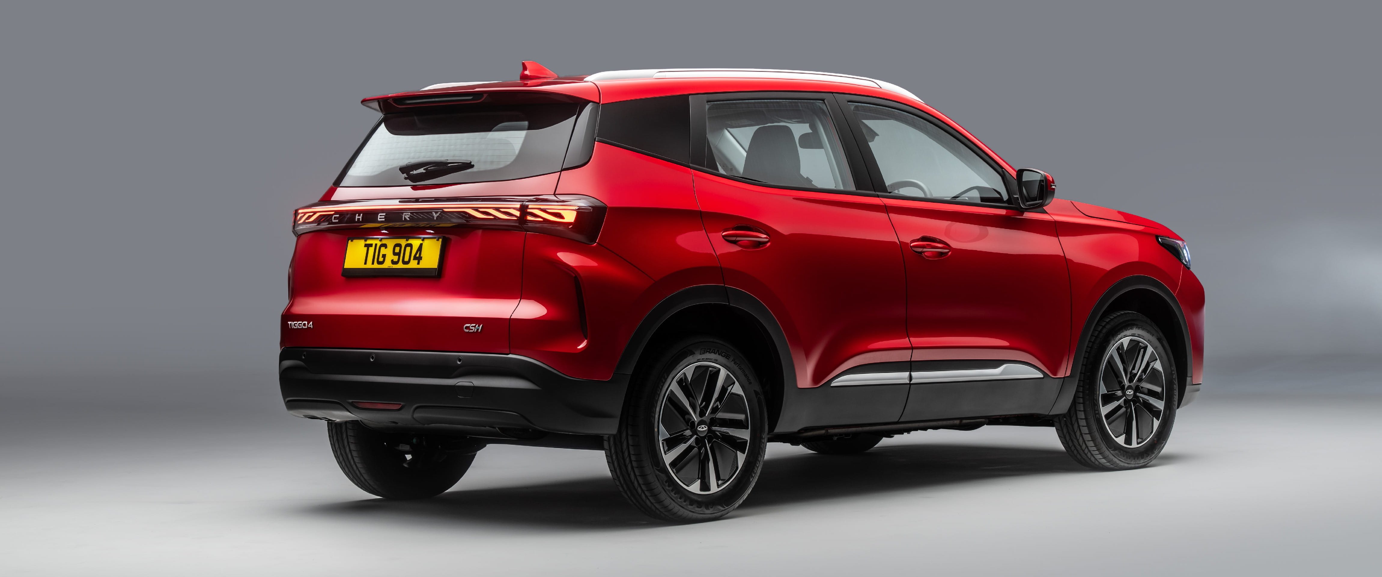 Red SUV viewed from the rear side with UK registration plate TIG 904.