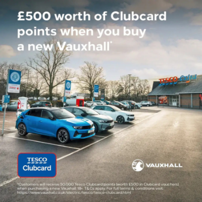 Vauxhall cars parked outside Tesco, promoting £500 Clubcard points offer with purchase.
